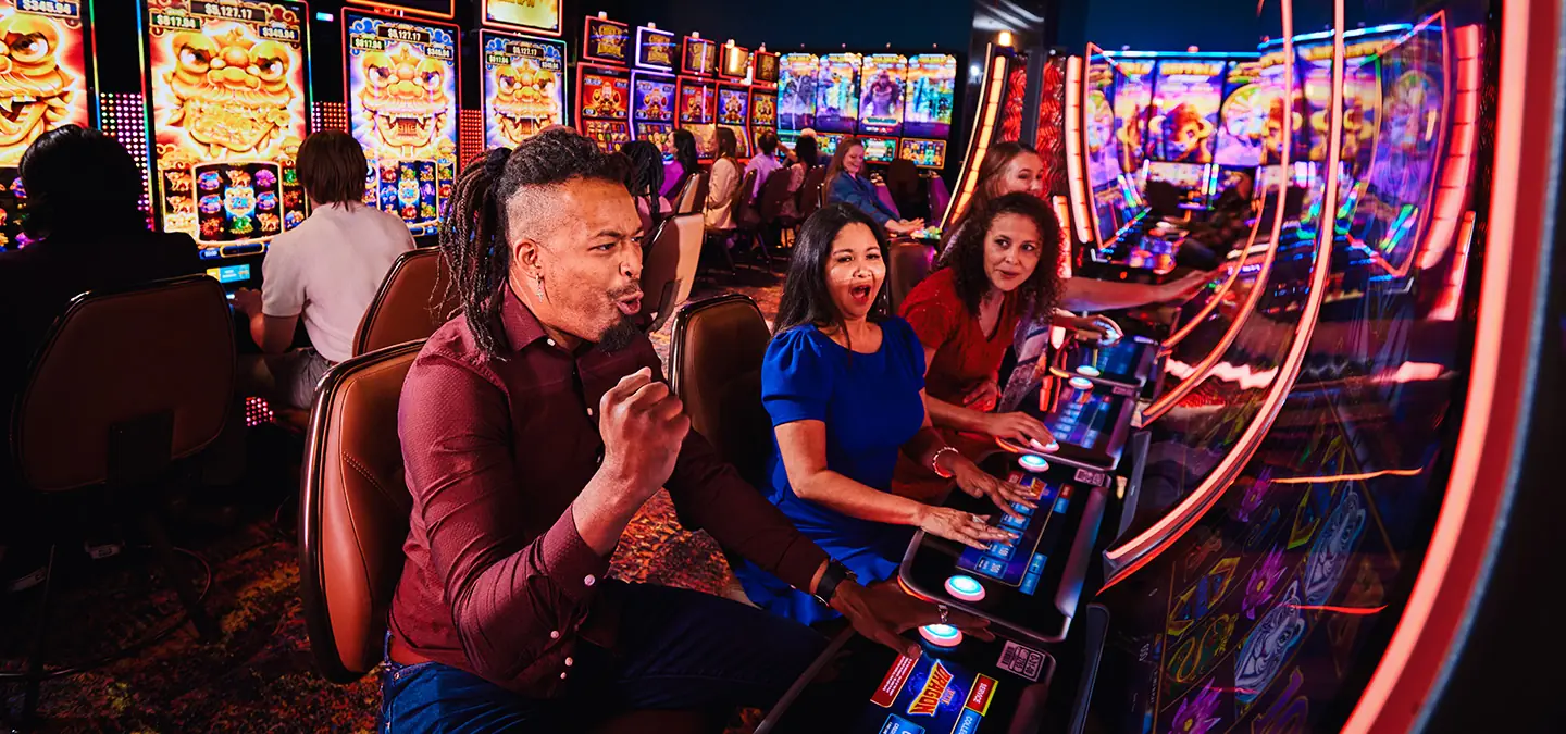 Friends celebrating winning at electronic games.